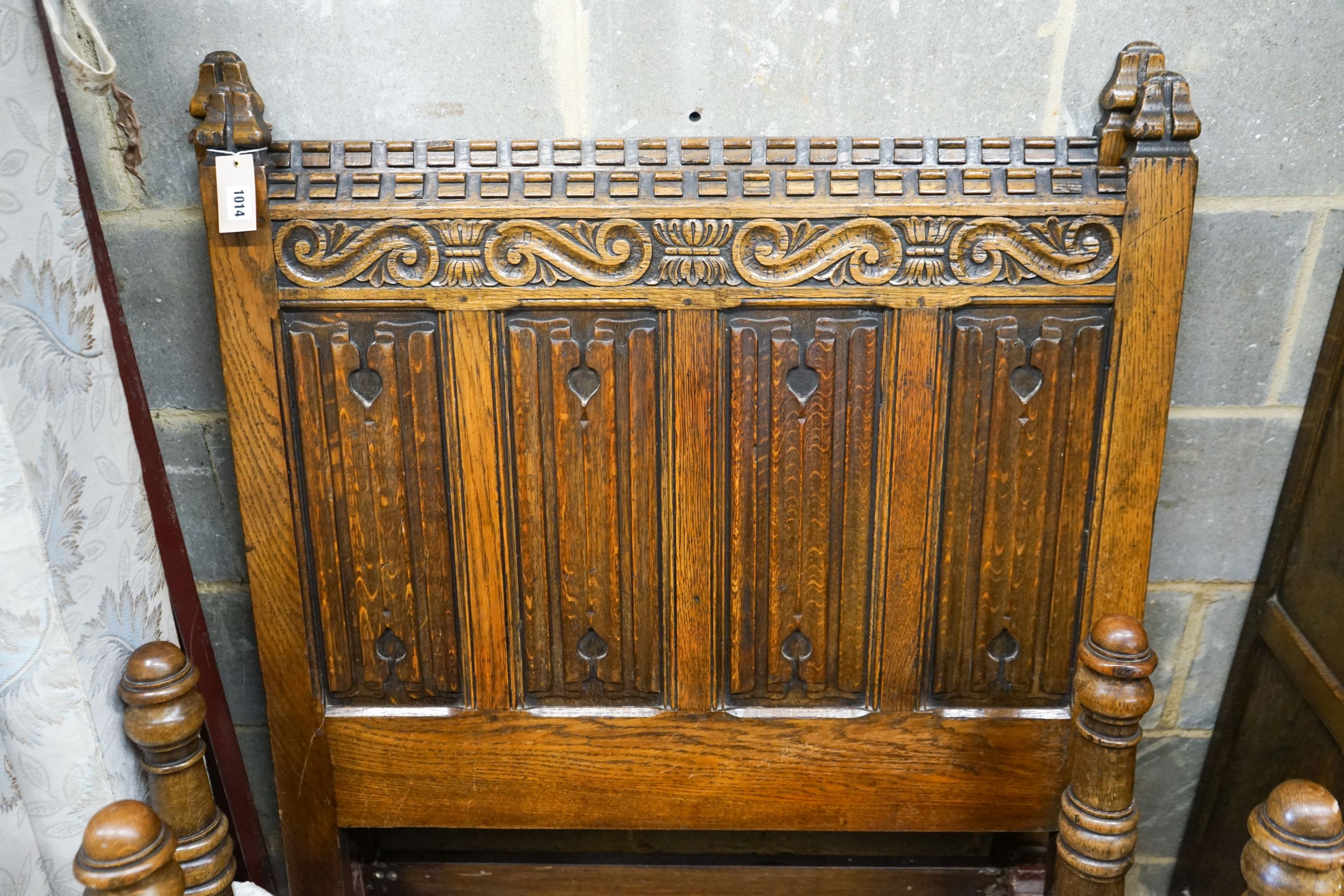 A 17th century style carved and panelled oak triple wardrobe with linenfold decoration, and a pair of early 20th century revival linenfold carved single bedframes, width 91cm, height 130cm